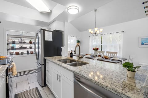 This fully equipped kitchen features stainless steel appliances, granite countertops, and a stylish backsplash — perfect for whipping up family meals.