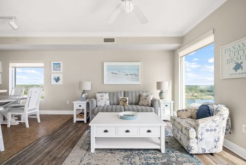 Relax in a bright coastal living room with beautiful beach views all around