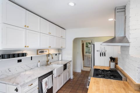 Fully stocked kitchen with marble and butcher block countertops for your use.