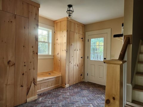 Entry way with built in closets and bench.