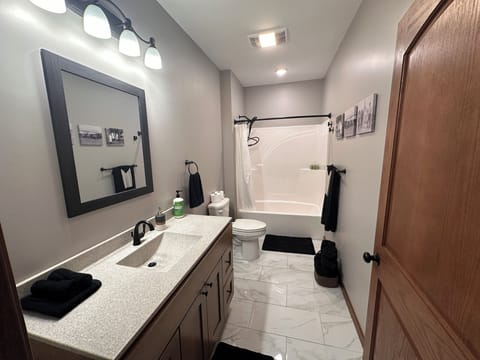 Spacious bathroom with all amenities provided.