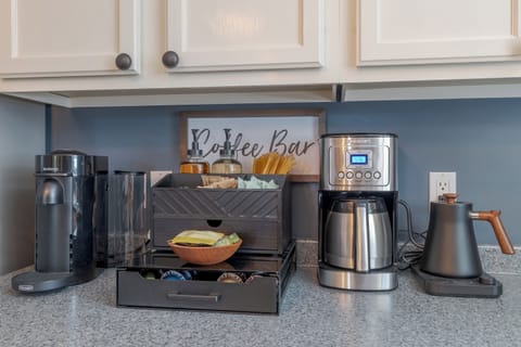 Coffee and tea bar, including Nespresso machine, drip coffee, french press, coffee grinder and assorted teas, coffees and add ons