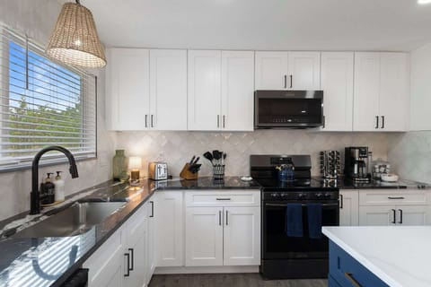 The kitchen is fully stocked with dishes, cookware, utensils, glasses and everything else you could need to cook a delicious meal. 