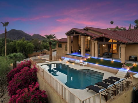 Front of the home with a stunning pool & jacuzzi ready for you to relax 