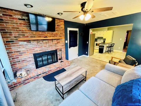 Den with wood burning fireplace