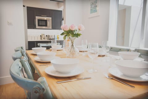 Dining area with a table and seating for 8 people.