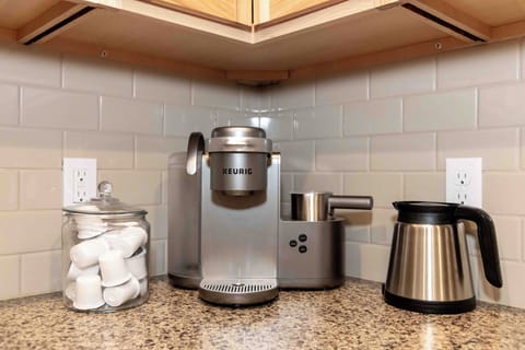 Keurig coffee maker with stocked coffee essentials.