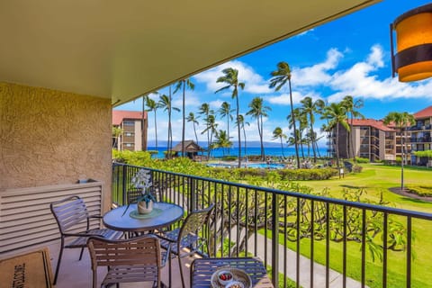 Unwind on a breezy balcony framed by palm trees and endless ocean horizons.