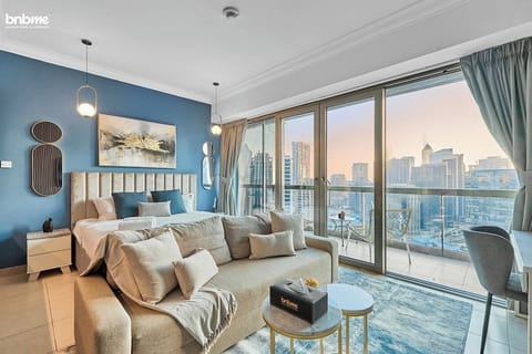 Cosy bedroom featuring a luxurious king bed and a comfortable sofa directly in front. Enjoy watching TV from either the bed or the sofa for ultimate relaxation.