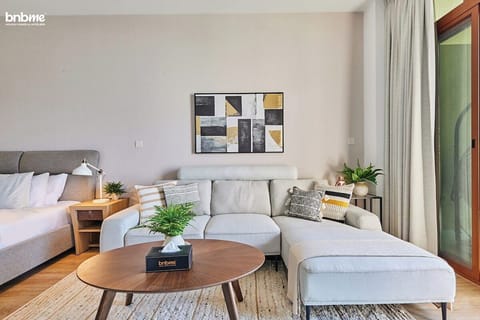 Relax in the inviting bedroom, complete with a luxurious king bed, a sofa for lounging, a work desk, and a TV to unwind after a long day.