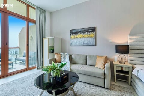 Unwind in the welcoming bedroom, featuring a luxurious king bed, a comfortable sofa for relaxation, and a TV to enjoy after a long day.