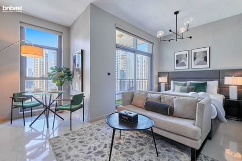 Comfort meets style with soft linen, a smart TV, and a sitting area that makes this studio feel like home.