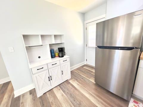 Coffee bar area with additional storage. Back door exit to the patio.