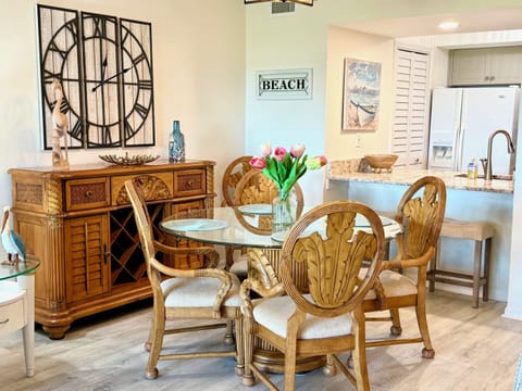 Gather for memorable meals at the elegant dining table, complemented by beautiful coastal decor and a convenient bar area.