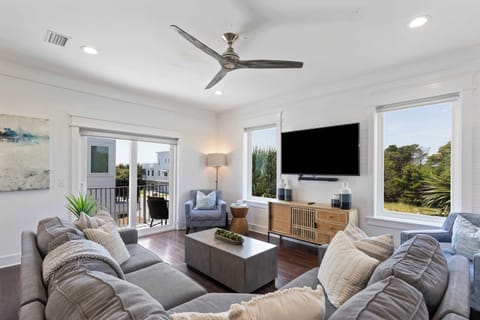 Living room [main floor]: Sectional seating, smart TV, patio access