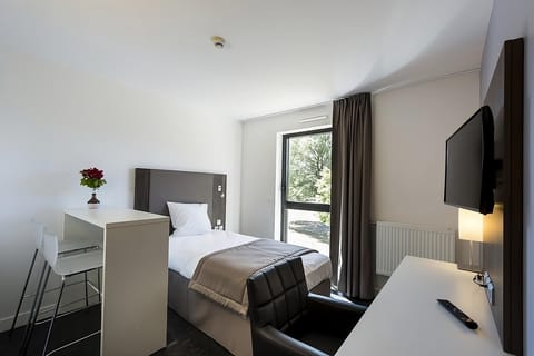 Relax after exploring with a comfy chair and in-room TV.