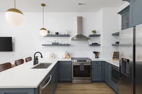 Condo 1 - Fully-stocked kitchen with high-end appliances and seating for 4 at the kitchen counter.