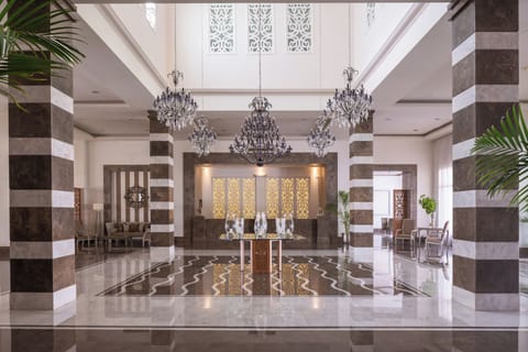 Arrive in style beneath glittering chandeliers and polished marble.