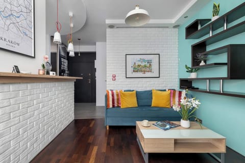 Bright living room with a colorful sofa and open kitchen creates a space where you can enjoy meals and relaxation together.