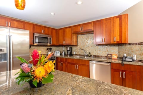 Chef-ready kitchen with granite countertops, stainless appliances, and a floral island welcome centerpiece HKH-423