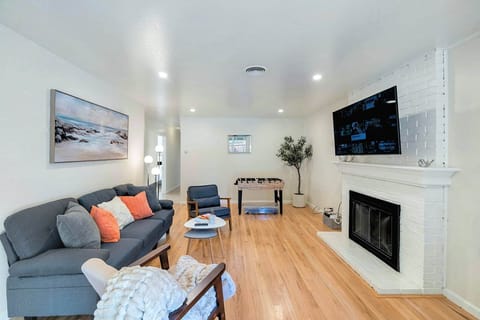 Cozy living room with a neutral palette, fireplace with built-in shelves, spacious gray sectional, l