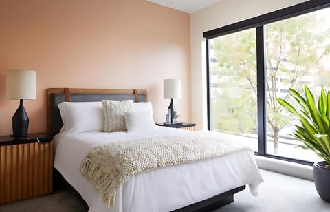 Unwind on crisp linens beside calming natural light.