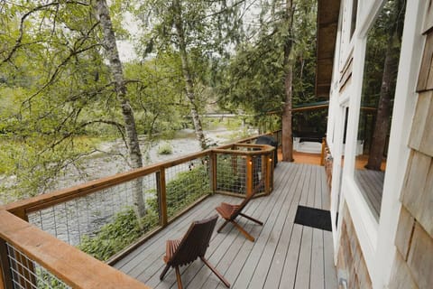 Expansive deck with seating, covered hot tub and grill - overlooking the Tilton River!