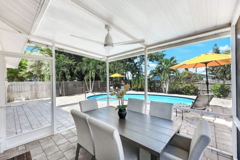 Enjoy breezy meals and morning coffee by the pool with shaded comfort and tropical views