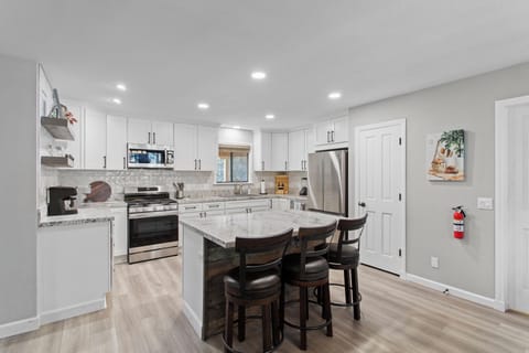 Spacious kitchen with large island and bar seating.