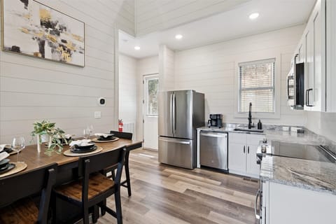 Fully equipped kitchen with stainless appliances, island seating, and family dining table.