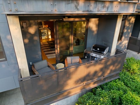 Step onto your private covered terrace where modern outdoor living meets comfort—savor BBQ evenings by the sleek grill, unwind in stylish lounge seating, and enjoy seamless indoor-outdoor flow through elegant glass doors
