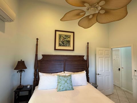 King Bed with AC comfort. Door separates the bedroom from the suite's private living room & bath.