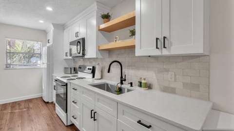 Modern, well-stocked kitchen and appliances, cookware, and utensils. Laundry area includes a washer and dryer, blending style and functionality for hassle-free stays.