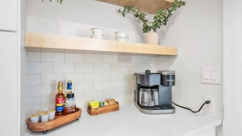 A cute coffee and tea bar with everything you need to start your day. Includes a coffee maker, a variety of coffee and tea options, sugar, and creamers. Thoughtfully designed for convenience and charm.