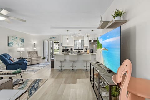 Bright, open-concept living room with comfy seating and plenty of natural light.