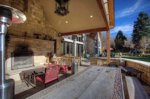 Relax outdoors by the stone fireplace on our covered patio, complete with comfortable seating and beautiful views, perfect for any season.