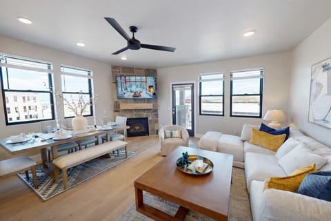 Relax in your bright open living space where modern comfort meets warmth, complete with cozy fireplace and stylish furnishings.