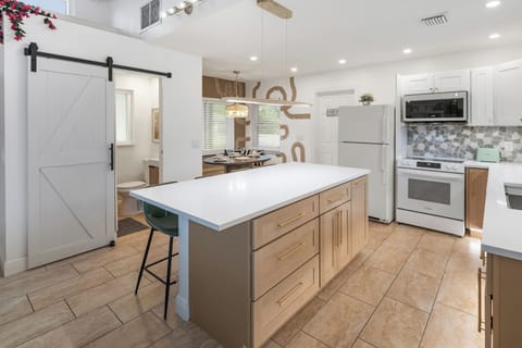 Fully renovated kitchen with a large island and all the amenities for cooking an