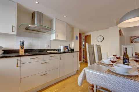 Ground floor: Kitchen area with an electric oven and hob, microwave, dishwasher and fridge