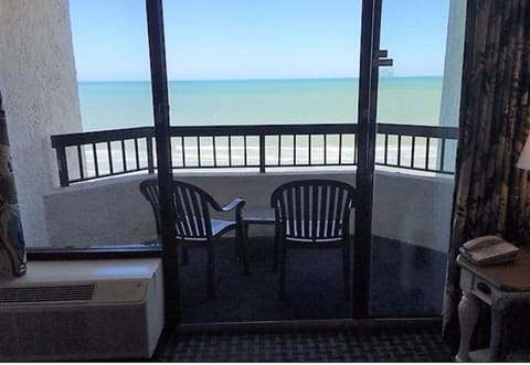 Private oceanfront balcony with seating to enjoy the views.