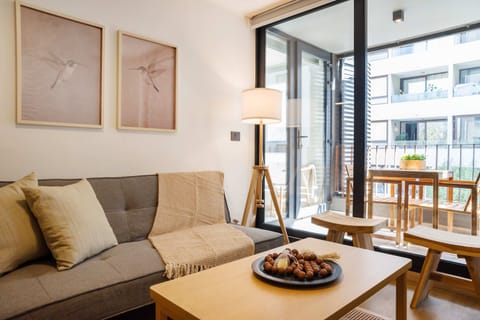 Cozy living area with balcony access, perfect for unwinding after a day of exploring.