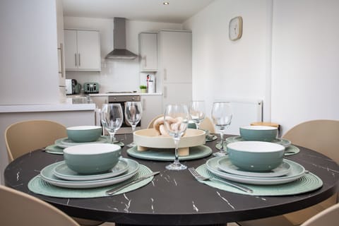 Bright dining area with a sleek kitchen just steps away