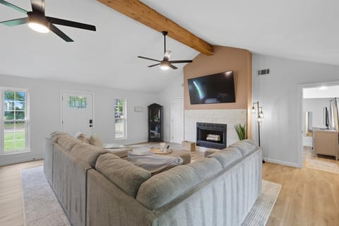 Featuring vaulted ceilings and a spacious open layout, this living room offers the perfect balance of southern rustic charm and elegant sophistication!