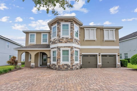 This beautiful two-story home boasts a charming stone exterior that combines rustic warmth with modern style. Ample windows fill the entrance with natural light, while the paved driveway enhances the impressive curb appeal.
