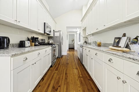 Kitchen | Fully equipped galley-style kitchen with stainless steel appliances, granite countertops, and ample cabinet space