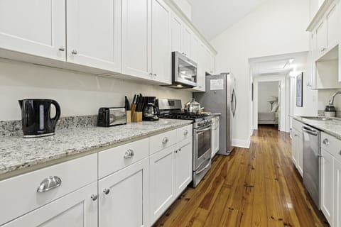 Kitchen | Fully equipped galley-style kitchen with stainless steel appliances, granite countertops, and ample cabinet space