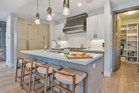 Chef-inspired kitchen with a large island, premium finishes, and seating for casual meals or après-ski bites - APRÈS style living at its best