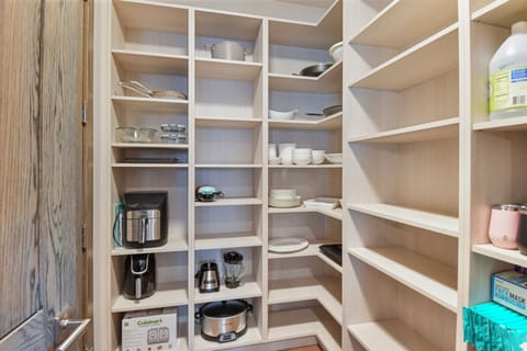 Spacious walk-in pantry with open shelving and thoughtful storage, making meal prep and entertaining effortless at Foundry Haus