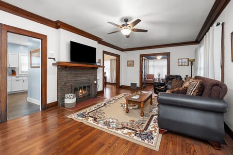 Welcome to our Craftsman historic home! Step into our living room--complete with leather plush seating, smart TV, colorful stained glass, board games, and extra chairs for family gatherings.