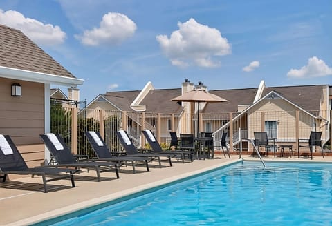 Dive into sunny afternoons by the sparkling outdoor pool.